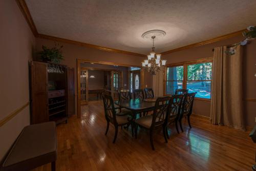 a dining room with a table and chairs at The Pointe in Greensboro