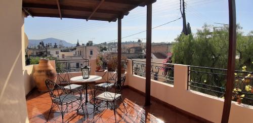 a patio with a table and chairs on a balcony at Villa Filiza in Sívas