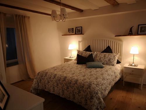 a bedroom with a bed with two night stands and two lamps at Space Nr. 11 in Merano