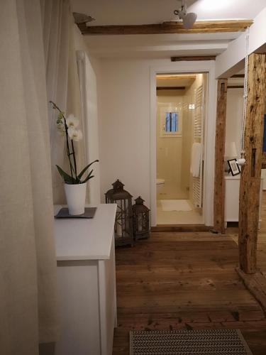 a bathroom with a vase of flowers on a counter at Space Nr. 11 in Merano