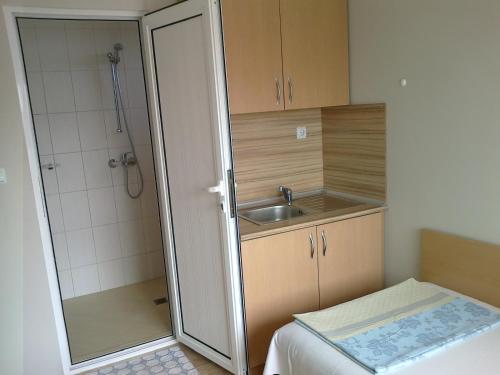 a small bathroom with a sink and a shower at Guest rooms Rusalka in Kranevo