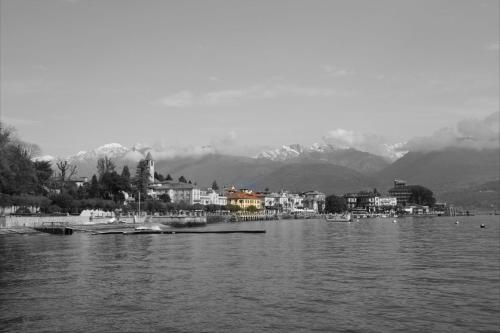 a large body of water with a town and mountains at Hotel Eden in Baveno