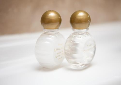 two glass vases with gold tops sitting next to each other at Griffin Inn in Newquay
