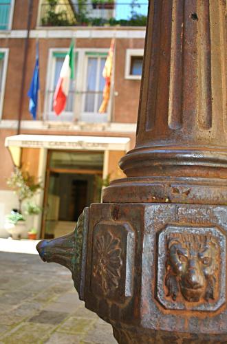 a close up of a fire hydrant with two flags at Hotel Carlton Capri in Venice