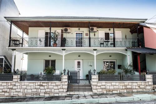 a large white house with a balcony at Guesthouse To Tzaki, in Konitsa