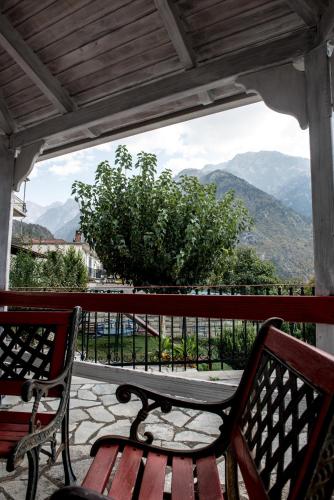 a bench on a balcony with a view of a mountain at Guesthouse To Tzaki, in Konitsa