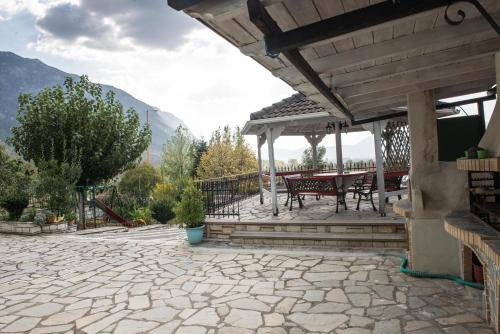 a patio with a table and chairs on it at Guesthouse To Tzaki, in Konitsa
