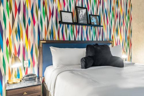 a bedroom with a bed with a colorful wall at Signature San Francisco in San Francisco