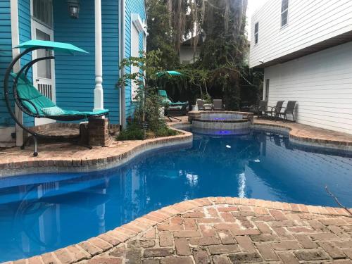 a swimming pool in front of a house at 4 BR - Sleeps 8! Best location next to Bourbon Street! in New Orleans