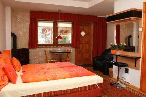 a bedroom with a bed and a living room at Vendégház 60 in Hatvan