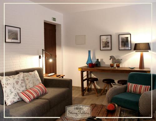 a living room with a couch and a table at Storytellers Villas in Sintra