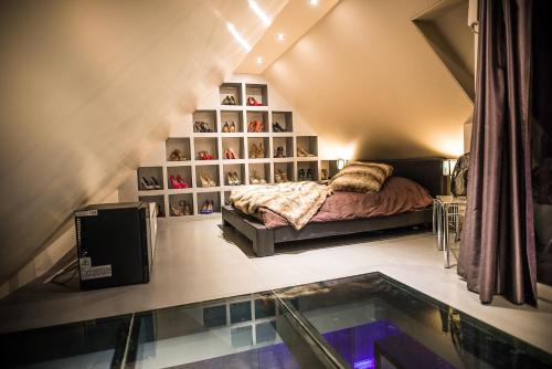 a bedroom with a bed and a glass floor at Loft Spa Cathedrale in Colmar