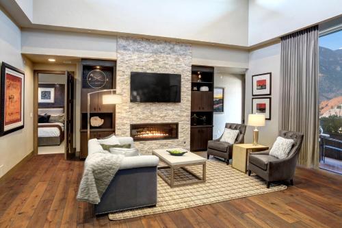 a living room with a couch and a fireplace at Garden of the Gods Resort & Club in Colorado Springs