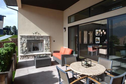 a patio with a fireplace and a table and chairs at Garden of the Gods Resort & Club in Colorado Springs