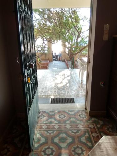 an open door to a patio with a tile floor at VILA INSPIRATION - ON KINI BEACH in Kinion