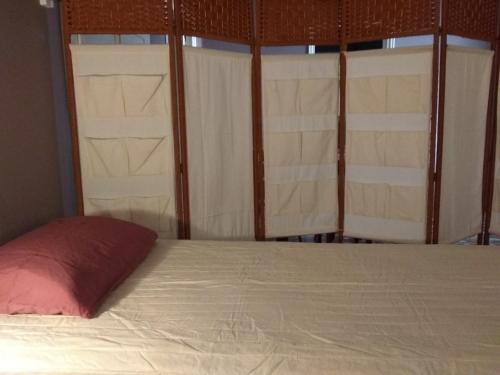 a bed in a room with two windows at VILA INSPIRATION - ON KINI BEACH in Kinion