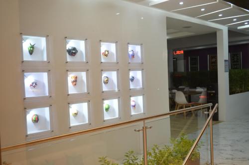 a wall of windows in a lobby with a staircase at Hotel Gran Mariscal Quito in Quito
