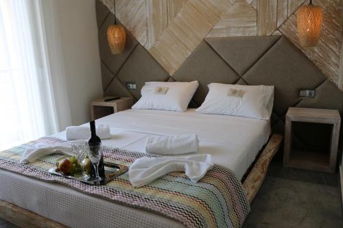 a bedroom with a bed with a bowl of fruit on it at Katrine Boutique Apartments in Kavala