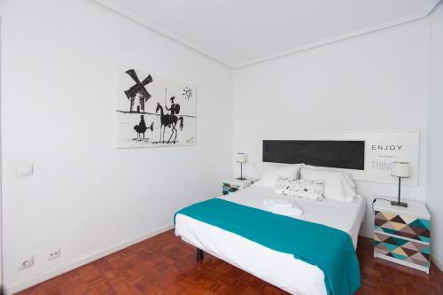 マドリードにあるHomelike Embajadoresの白いベッドルーム(ベッド1台付)が備わります。壁に絵が描かれています。