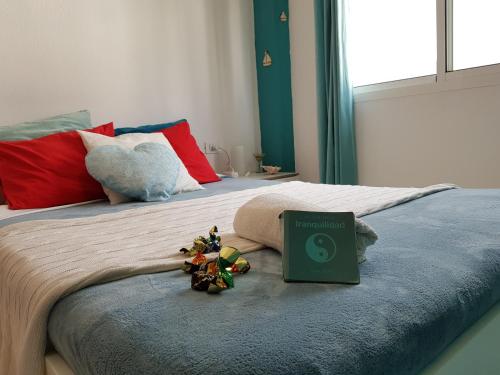 a bed with a book on it with flowers on it at THE HAPPINESS PENTHOUSE Dream Holiday at 100m Beach in Candelaria