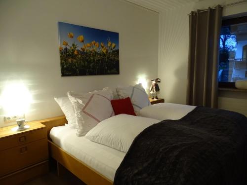 a bedroom with a bed with a painting on the wall at Sportpension Christina by PiaundDirk in Fügen