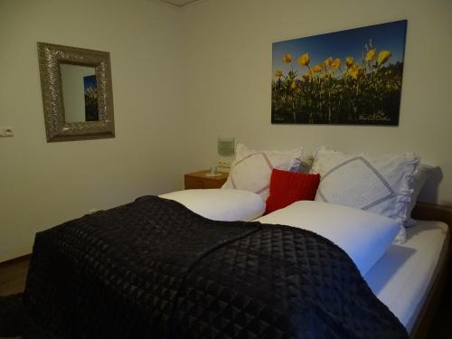 a bedroom with two beds and a picture of flowers at Sportpension Christina by PiaundDirk in Fügen