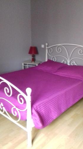a white bed with a purple blanket on it at Gîte Etchegoyhen in Lacarry-Arhan-Charritte-de-Haut