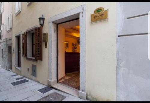 an entrance to a building with a door open at Hotel Capitelli in Trieste