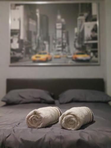 two towels sitting on top of a bed at Standard Apartment by Prima Lodging in Thessaloniki