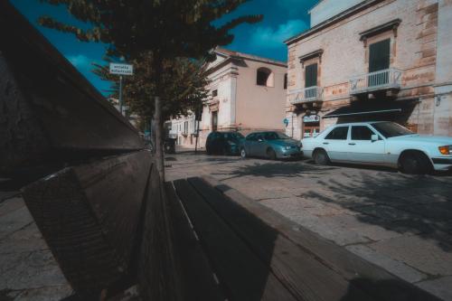 a white car parked on a city street at Il Vicolo - Affittacamere in Ruvo di Puglia