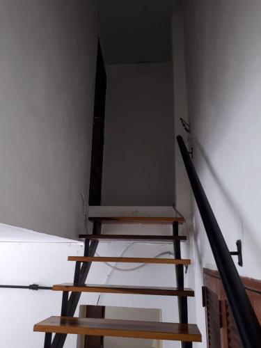 a set of stairs in a room with a mirror at departamento microcentro in Paraná