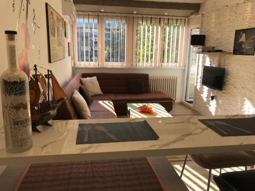 a living room with a couch and a table at Lovely Apartment 2 in Belgrade