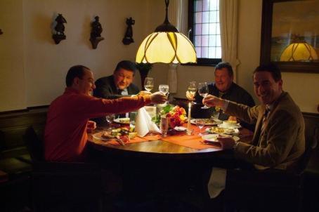 a group of men sitting around a table drinking wine at Hotel Goldener Karpfen in Aschaffenburg