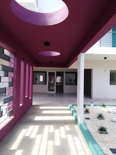 a building with a purple ceiling and a hallway at garden33 in Chivilcoy