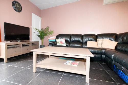 a living room with a leather couch and a coffee table at jutta in Mechelen