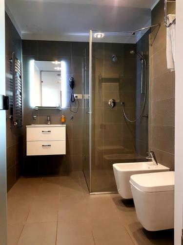 a bathroom with a shower and a toilet and a sink at Azymut Hotel - Restauracja in Andrespol