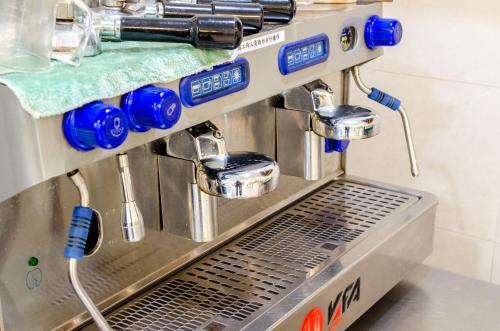 a coffee machine in a kitchen with blue controls at 光腳丫宜蘭民宿 in Dongshan