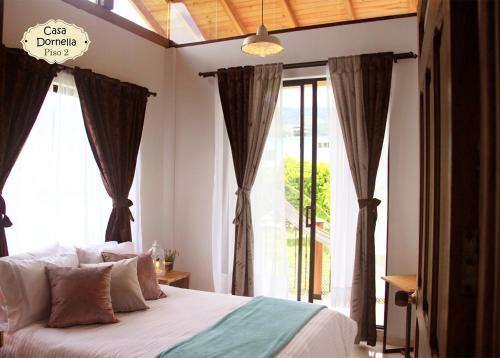 a bedroom with a bed and a large window at Casa Dornella - Casa de Hospedaje in Guaduas