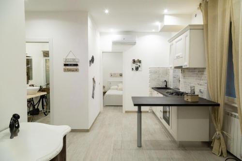 a kitchen with white cabinets and a black counter top at Eur Home in Rome