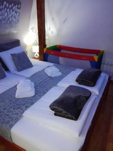 two beds in a room with towels on them at Blue Danube Apartment in Belgrade