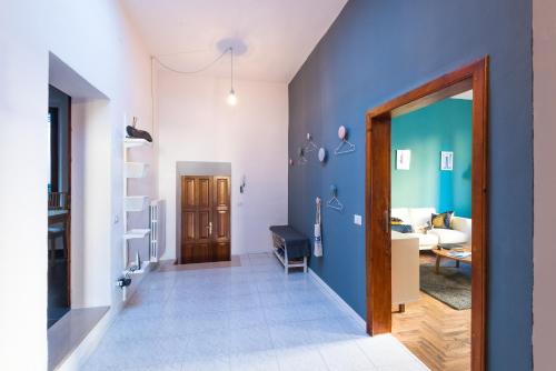 a hallway with blue walls and a living room at Your home in Trequanda in Trequanda