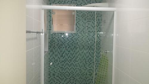 a bathroom with a shower with a glass door at Apto Novo a uma Quadra da Praia in Guarujá
