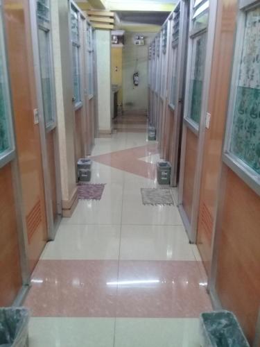 an empty hallway in a building with doors and windows at ASHBURN'S TRANSIENT BAGUIO - 3rd to 5th floor BASIC SLEEP and GO Accommodation, WITH PARKING, NO ELEVATOR in Baguio