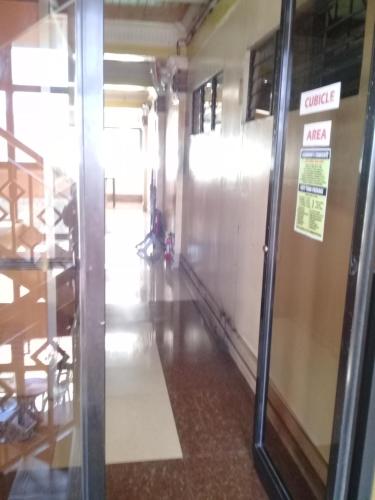 a hallway in a building with a sliding glass door at ASHBURN'S TRANSIENT BAGUIO - 3rd to 5th floor BASIC SLEEP and GO Accommodation, WITH PARKING, NO ELEVATOR in Baguio