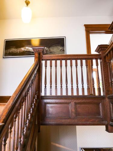 a wooden staircase in a house with a picture on the wall at Shadowcrest in Fleischmanns