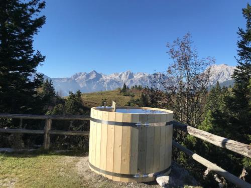 a wooden barrel on a fence with mountains in the background at Chalet Tisa Velika Planina in Stahovica