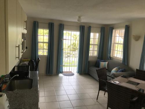 a living room with blue curtains and a couch at Turtle Ridge Apartments in Saint James