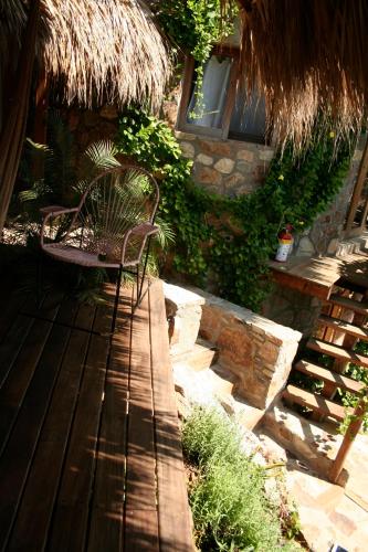 a bench sitting on a deck in front of a building at Hotel Sal de Mar in San Agustinillo