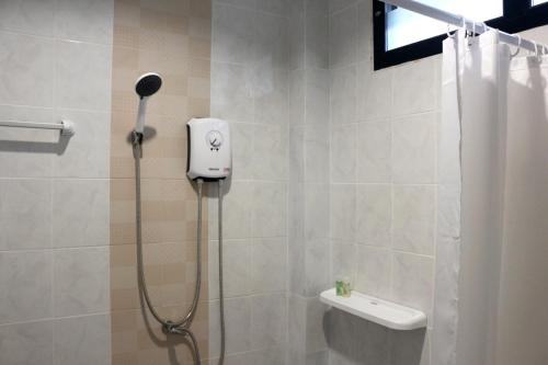 a shower with a blow dryer in a bathroom at The Lodge at Koh Kood in Ko Kood