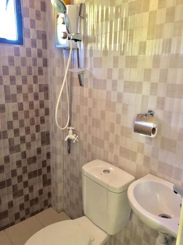 a bathroom with a toilet and a sink at Chaniva-Joy Island View Appartments in Malapascua Island